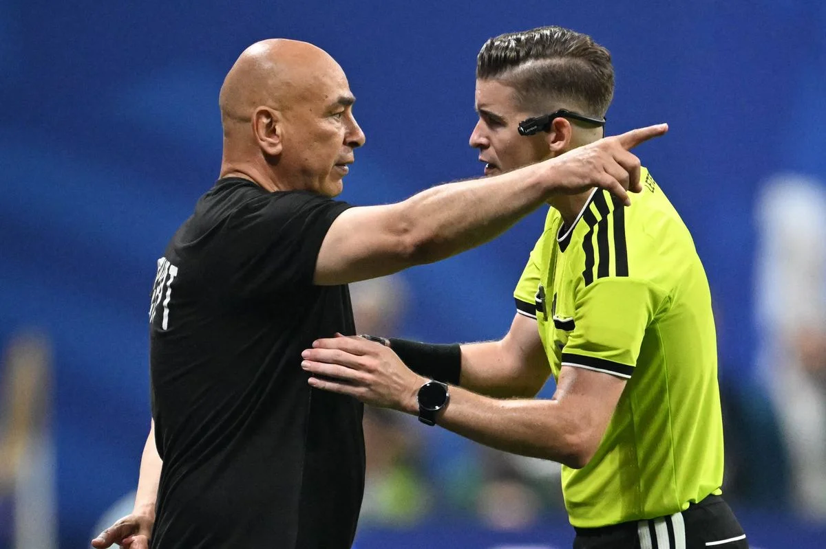 Egypt's head coach Hossam Hassan speaks with French referee Francois Letexier during the 2026 World Cup round of 16 football match between Argentina and Egypt at Atlanta Stadium in Atlanta on July 7, 2026