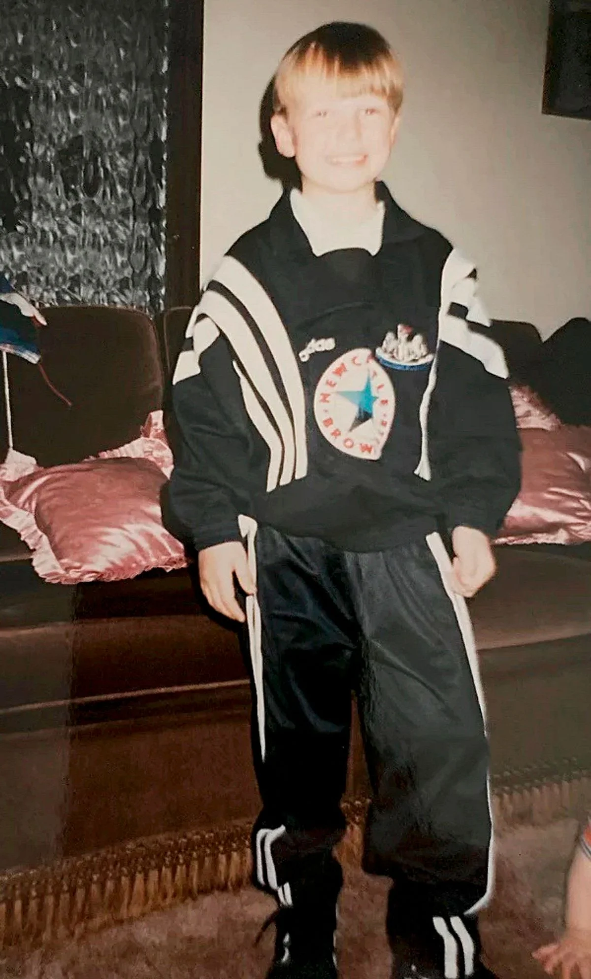 A young Dan Burn sporting a classic mid-1990s Magpies top