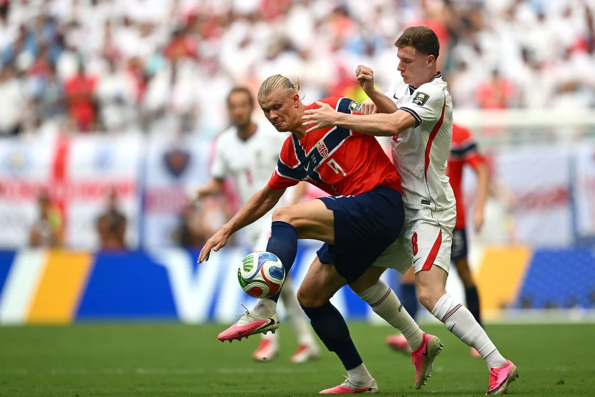 Erling Haaland of Norway competes for the ball against Elliot Anderson of England
